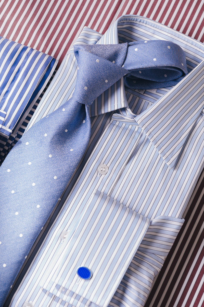 Blue striped shirt with a matching tie on a striped background