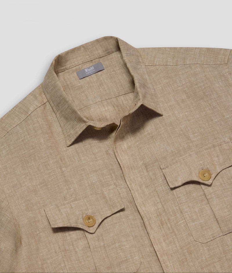 Beige shirt with button details on a light gray background