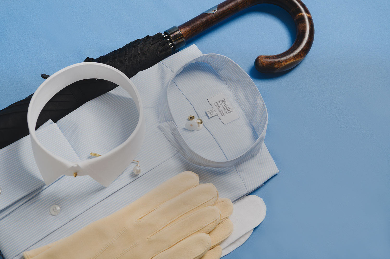 Collar, tie, and gloves on a blue background