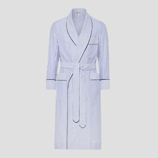 A long white bathrobe with thin vertical navy blue stripes and dark piping trim, shown on a neutral light gray background.