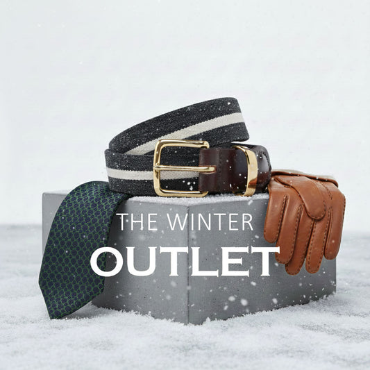 Winter accessories including a belt, gloves, and a scarf on a snowy background with 'The Winter Outlet' text.