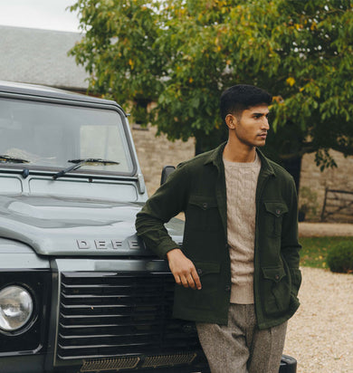 Man standing next to a Land Rover vehicle outdoors